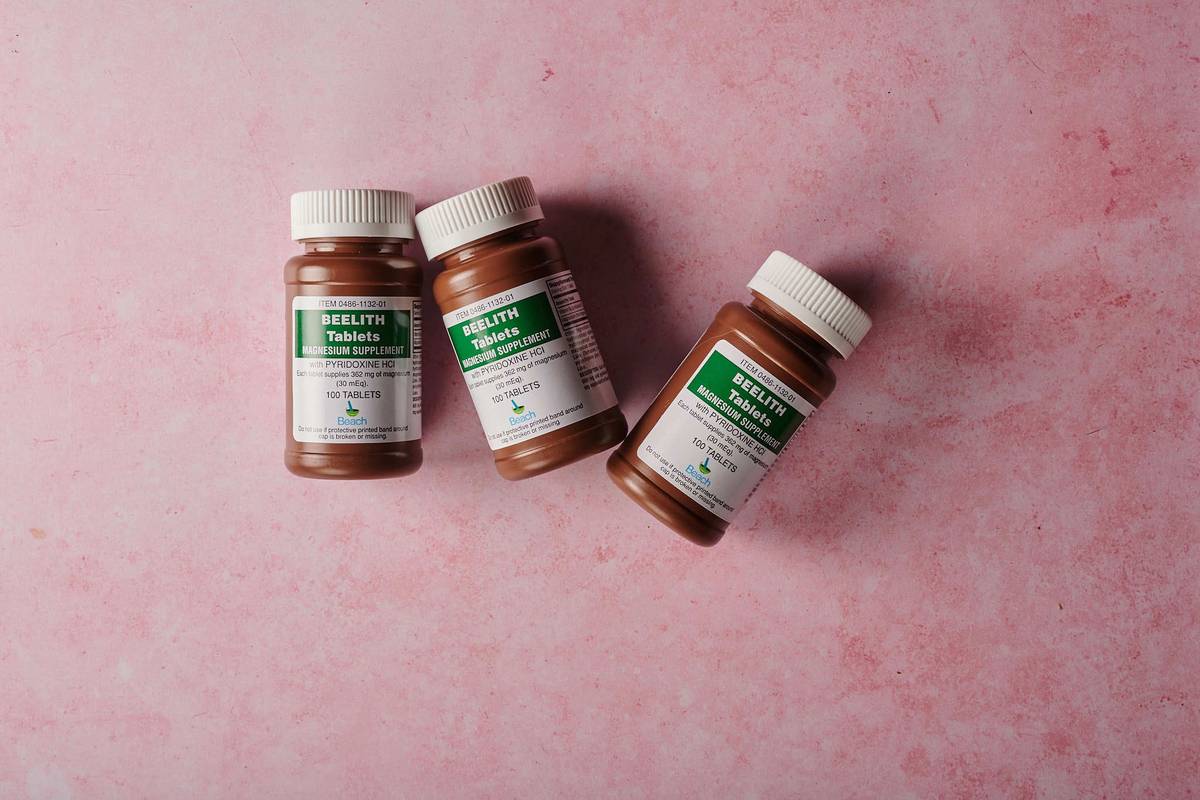 Kelp for Trace Mineral Support: dried kelp powder beside dog vitamins in glass jars